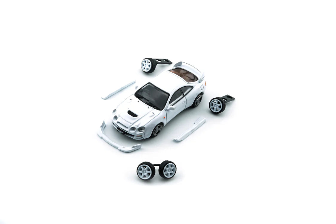 White toy car with additional wheels on a white background