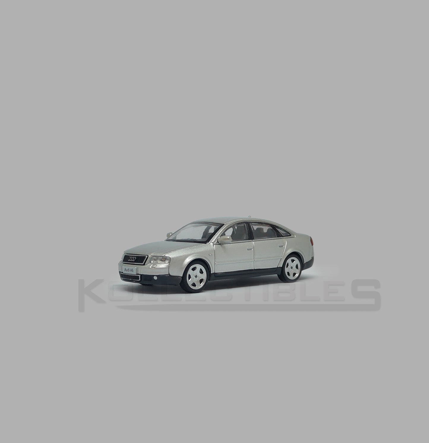 Perspective view of Audi A6 second generation (C5) metallic silver 1:64 scale model car - Xcartoys x Poprace