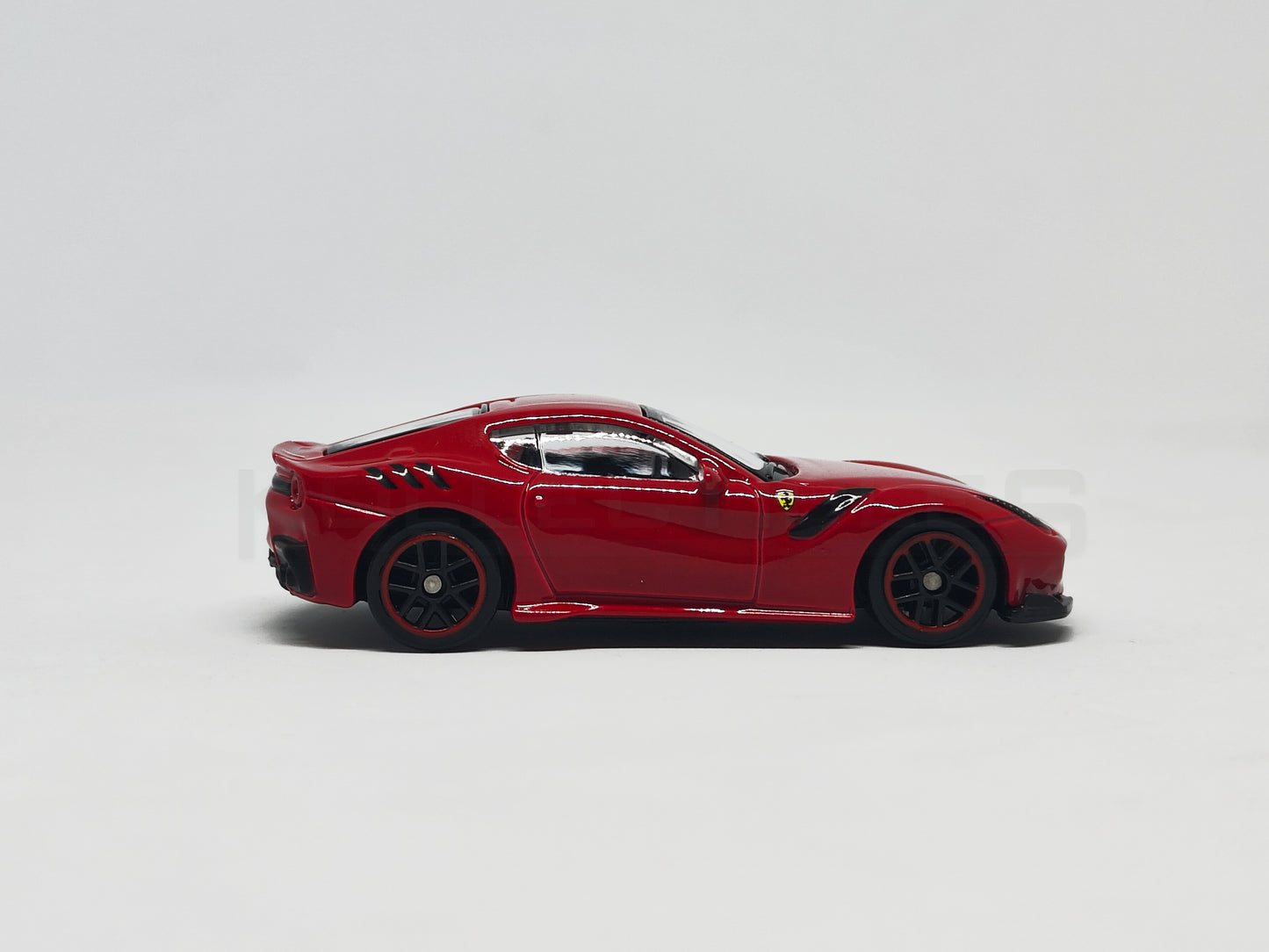 side1 view of F12DTF Red 1:64 scale model car 1:64 scale model car - Bburago