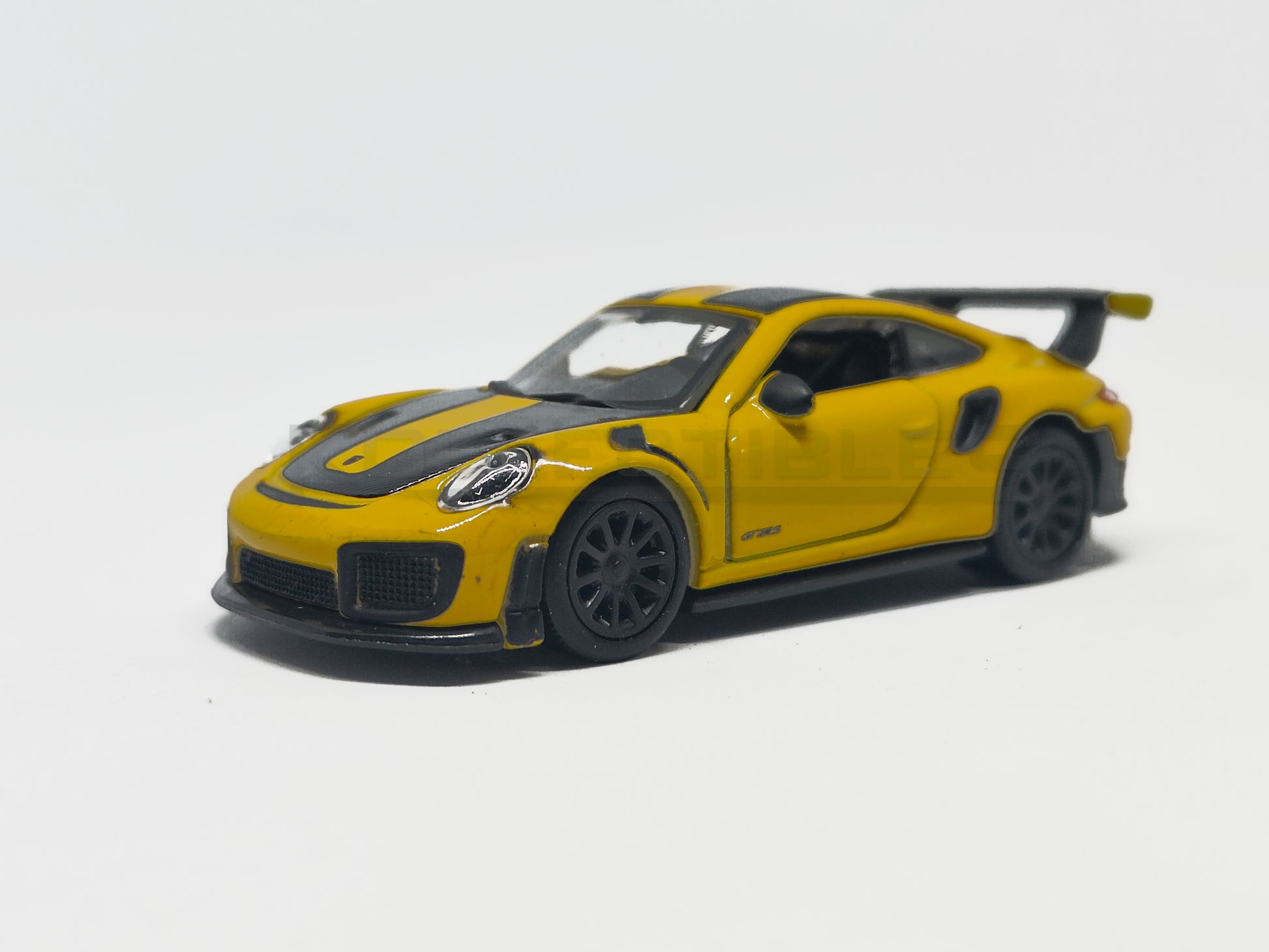 front view of Porsche GT2 RS Yellow 1:64 scale model car - Bburago