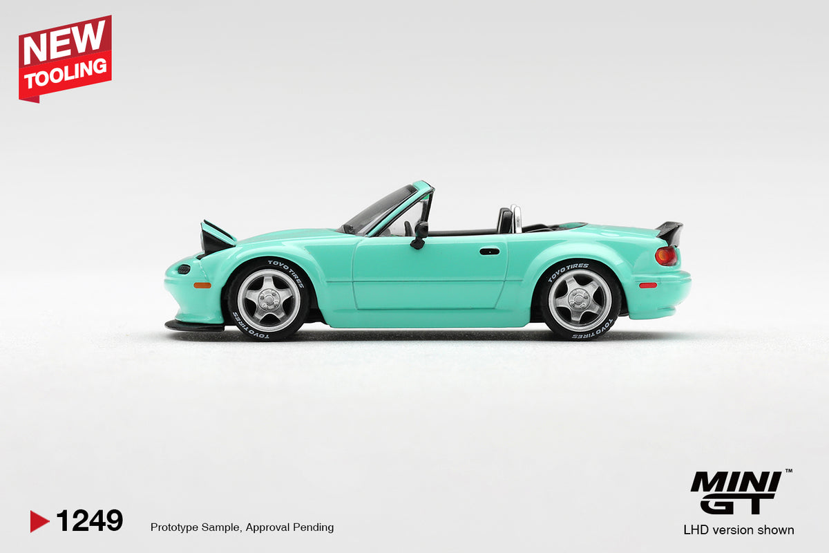 Mini GT Mazda MX-5 (NA) Pandem mint green 1:64 scale diecast model car, side profile showing the widebody arches and TOYO TIRES lettering