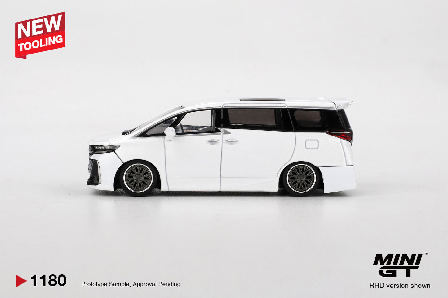 Side view of Toyota Vellfire 40 KUHL White 1:64 scale model car showing the slammed stance and dark multi-spoke wheels (MGT01180)