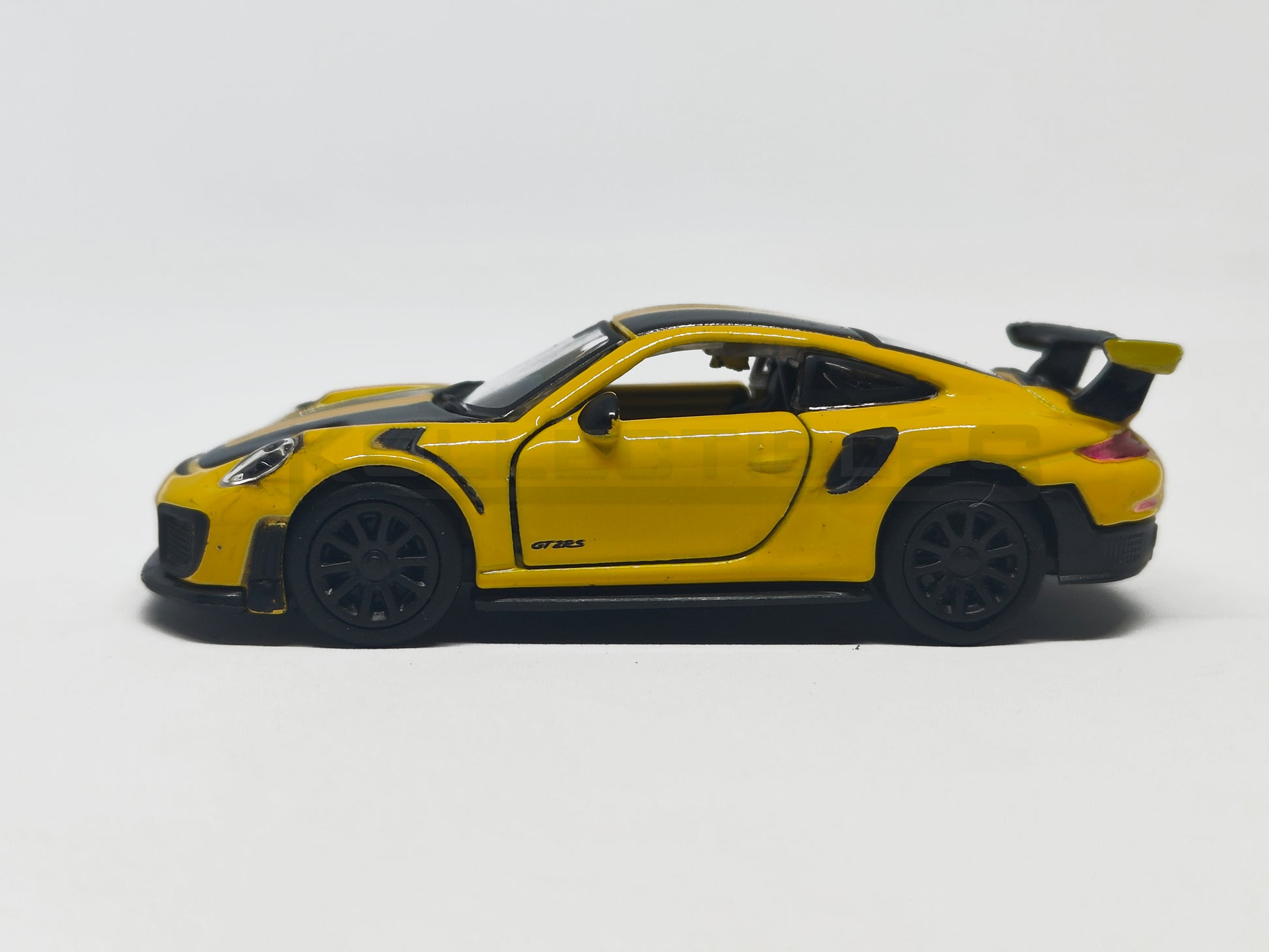 side1 view of Porsche GT2 RS Yellow 1:64 scale model car - Bburago