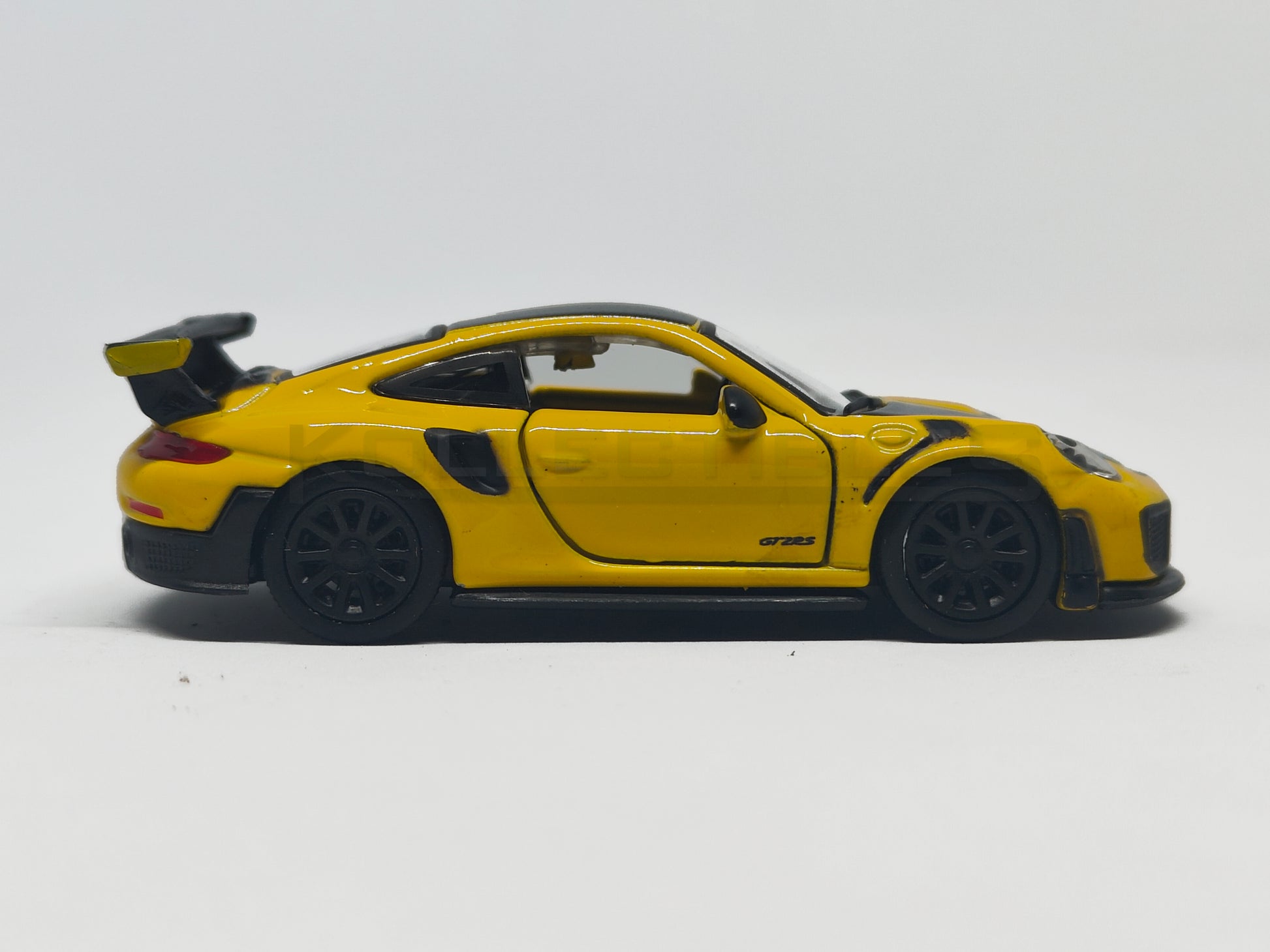 side2 view of Porsche GT2 RS Yellow 1:64 scale model car - Bburago