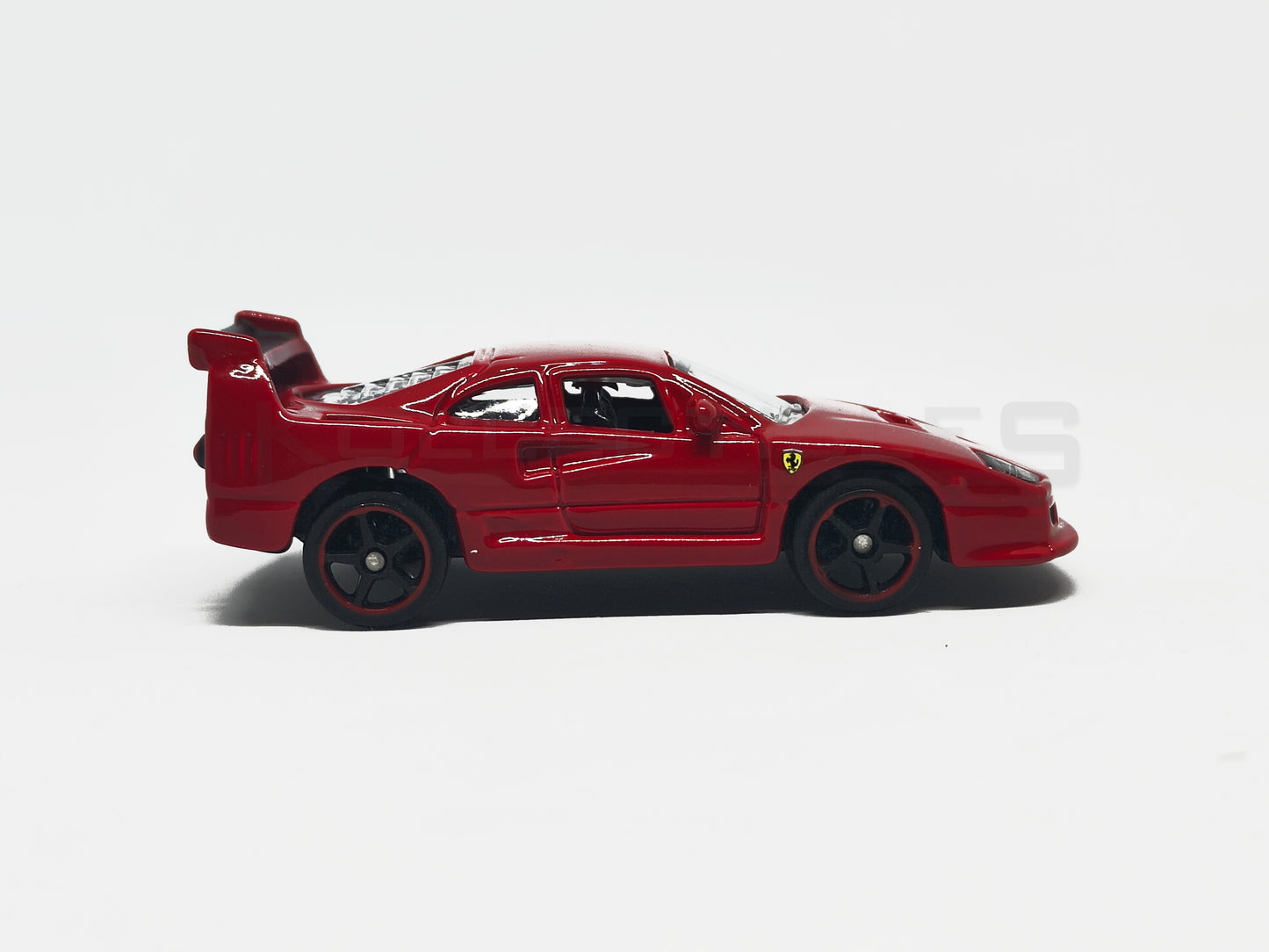 Side view of Ferrari F40 Competizione Red 1:64 scale model car - Bburago