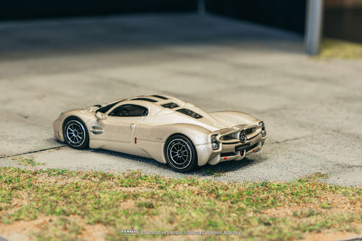 Model car on a concrete surface with grass in the foreground