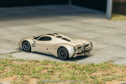 Model car on a concrete surface with grass in the foreground