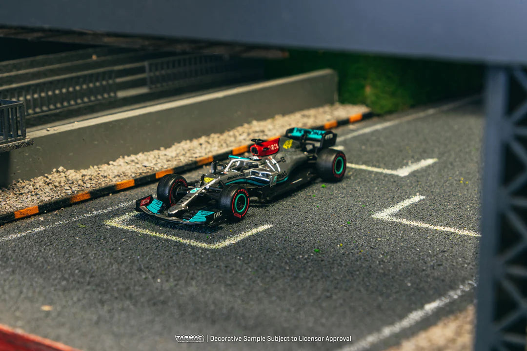 Model Formula 1 car on a miniature race track with a blurred background