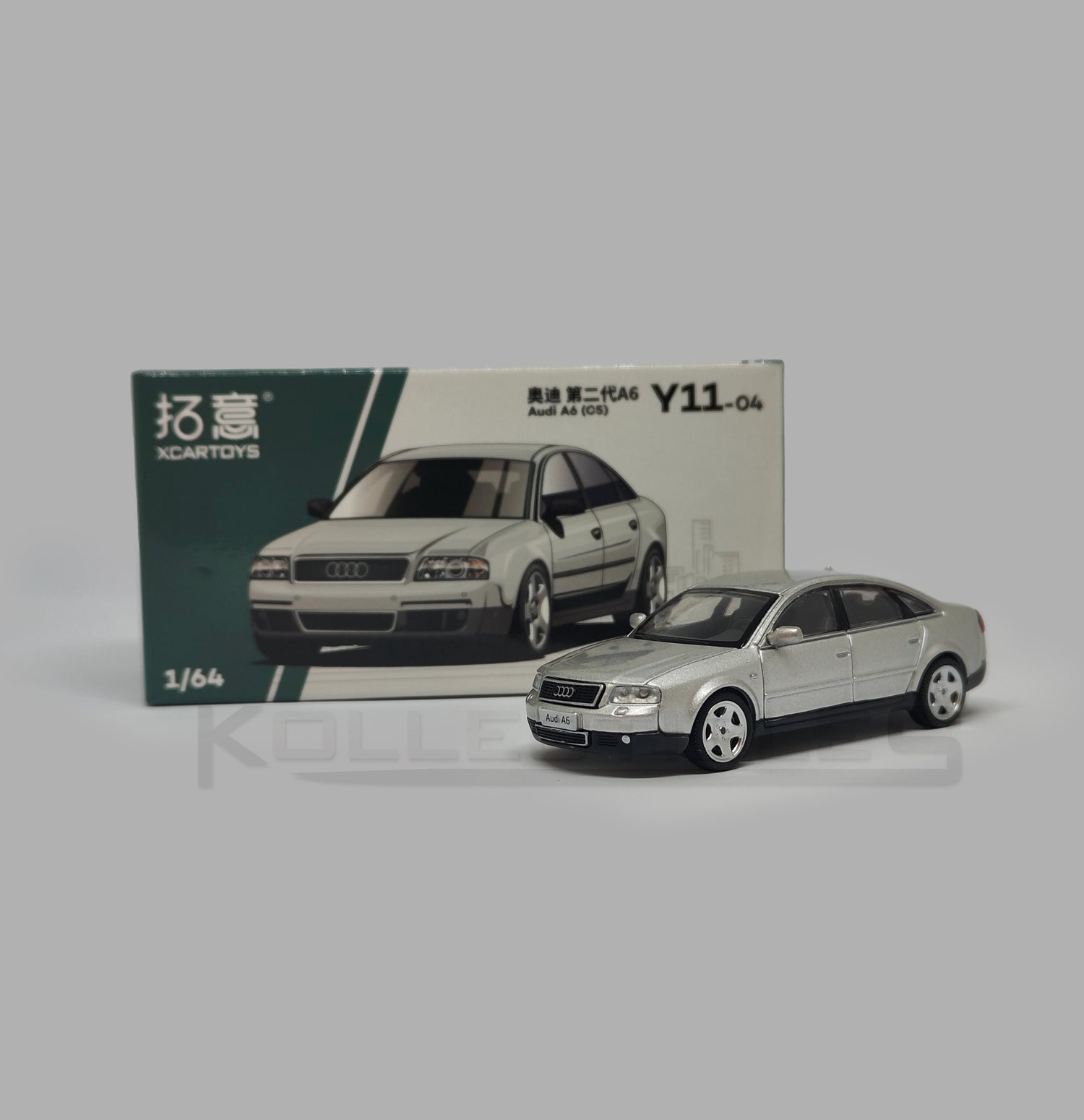 Perspective view with Box of Audi A6 second generation (C5) metallic silver 1:64 scale model car - Xcartoys x Poprace