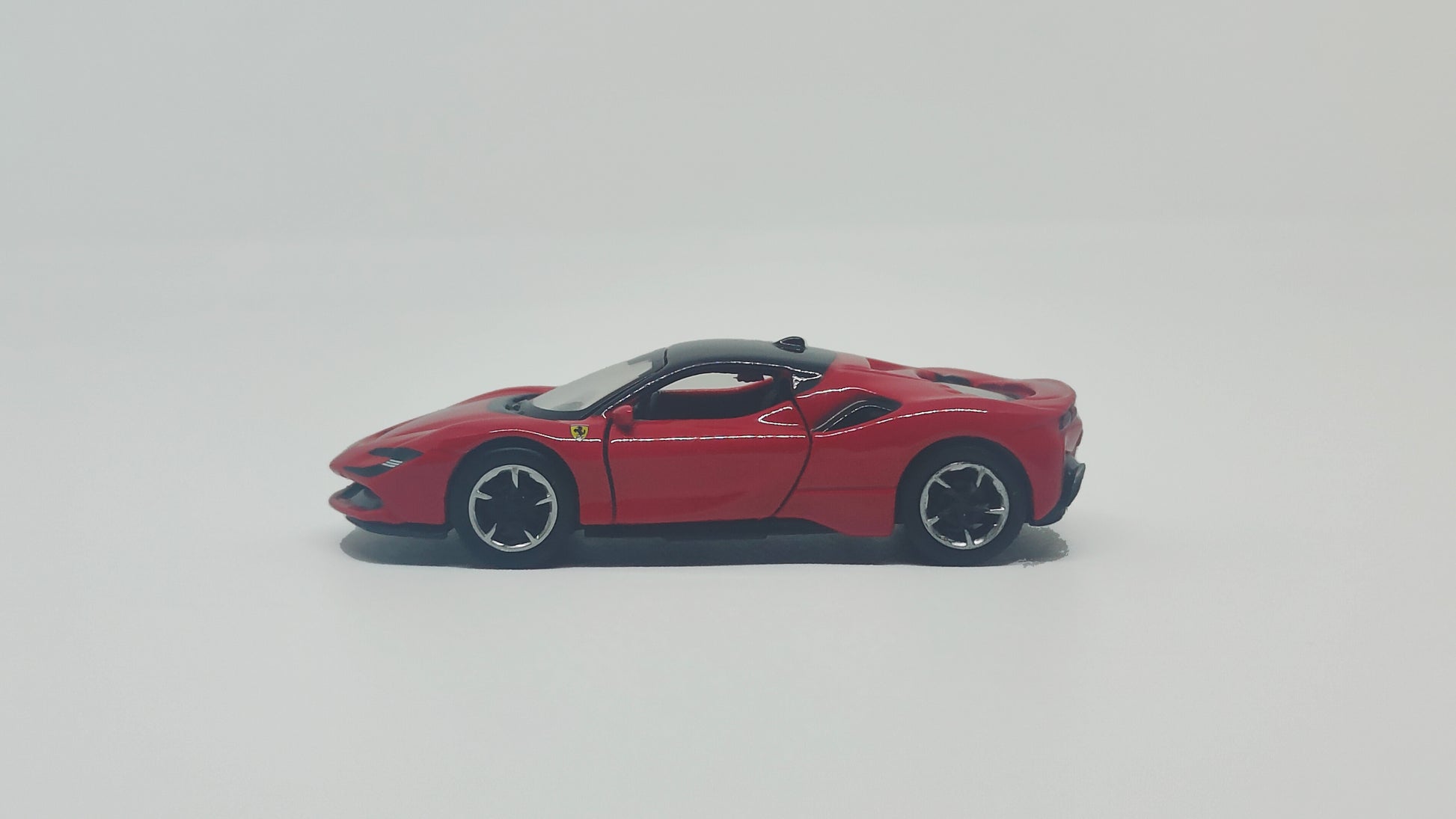 side view of Ferrari SF90 Red 1:64 scale model car - Bburago