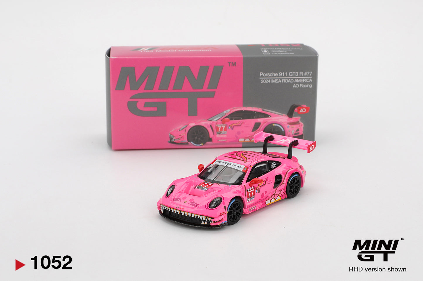 Pink model car with 'MINI GT' packaging on a white background