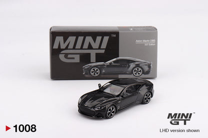 Black model  Aston Martin DBS car in front of its packaging with 'MINI GT' branding on a white background.