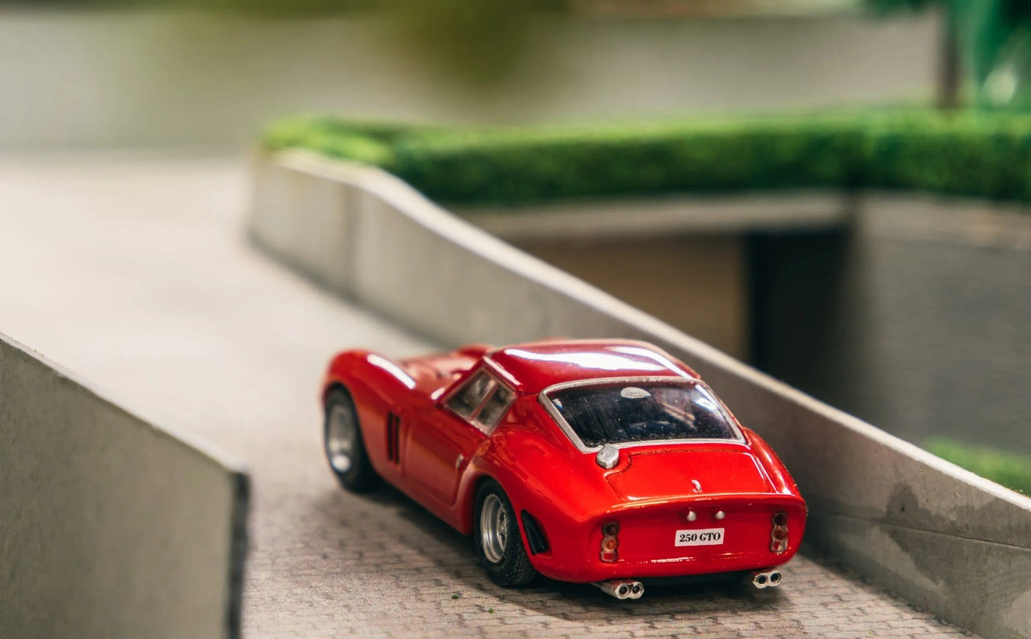 Rear three-quarter view of Ferrari 250 GTO 1962 1:64 diecast showing the Kamm tail, integrated spoiler and twin exhausts (IXC.FSD.FE.006-E)
