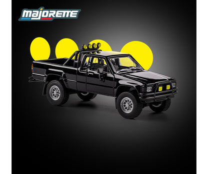 front perspective view of 1985 Toyota Hilux SR5 Pickup Black 1:64 Scale Model Car – Majorette Premium (Product Code: 8505001016)