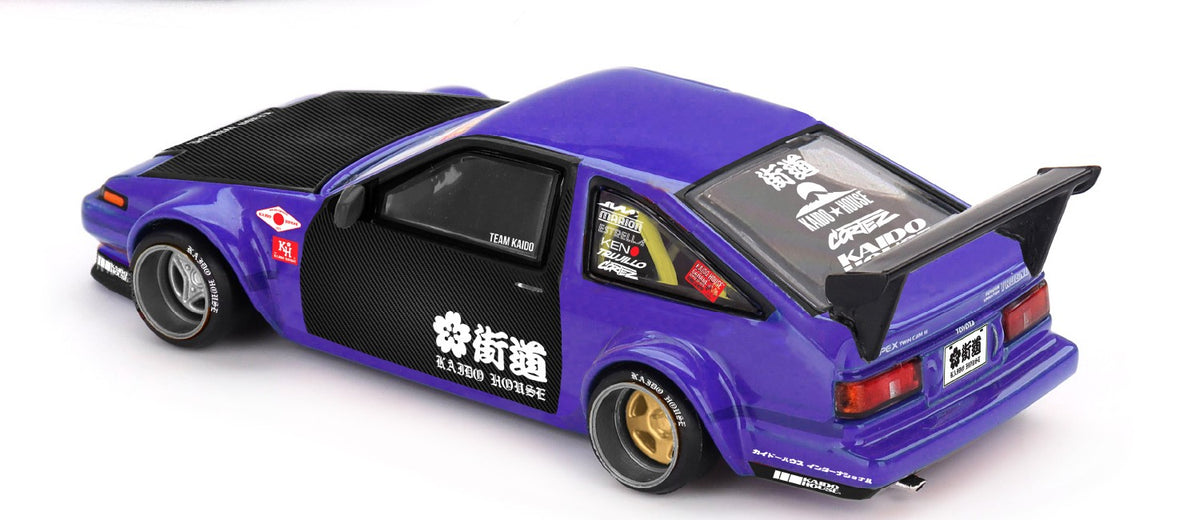 Kaido House x Mini GT Toyota AE86 Sprinter Trueno Kaido Touge V1 purple and black 1:64 scale diecast model car, rear three-quarter view showing the swan-neck GT wing and Kaido House rear quarter roundel