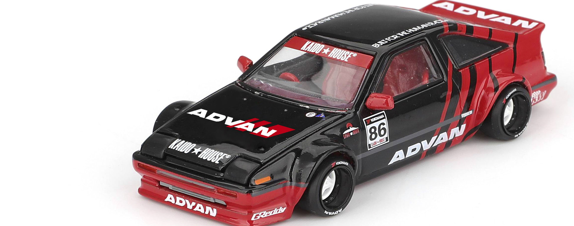 Rear view of Toyota AE86 Sprinter Trueno Kaido ADVAN 1:64 diecast showing the ADVAN rear wing and widebody rear fenders (KHMG0214)