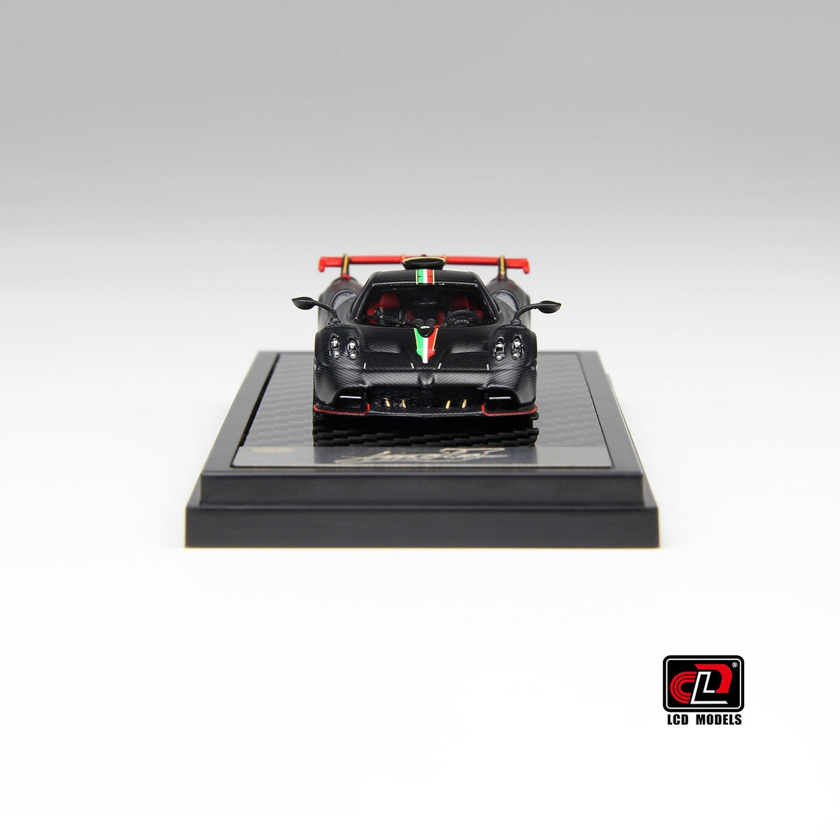 Rear view of Pagani Imola 1:64 diecast showing the red multi-element rear wing on gold uprights and quad exhausts (LCD64041-MBCI)