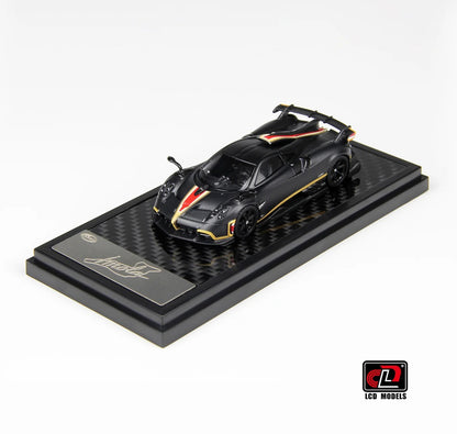 Front three-quarter view of Pagani Imola matte black carbon 1:64 diecast model car by LCD Models with gold pinstriping on its display base (LCD64041-MBC)