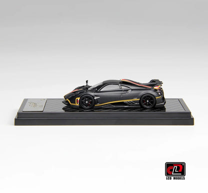 Side profile of Pagani Imola matte black carbon 1:64 scale model car showing the exposed carbon weave and black five-spoke wheels (LCD64041-MBC)