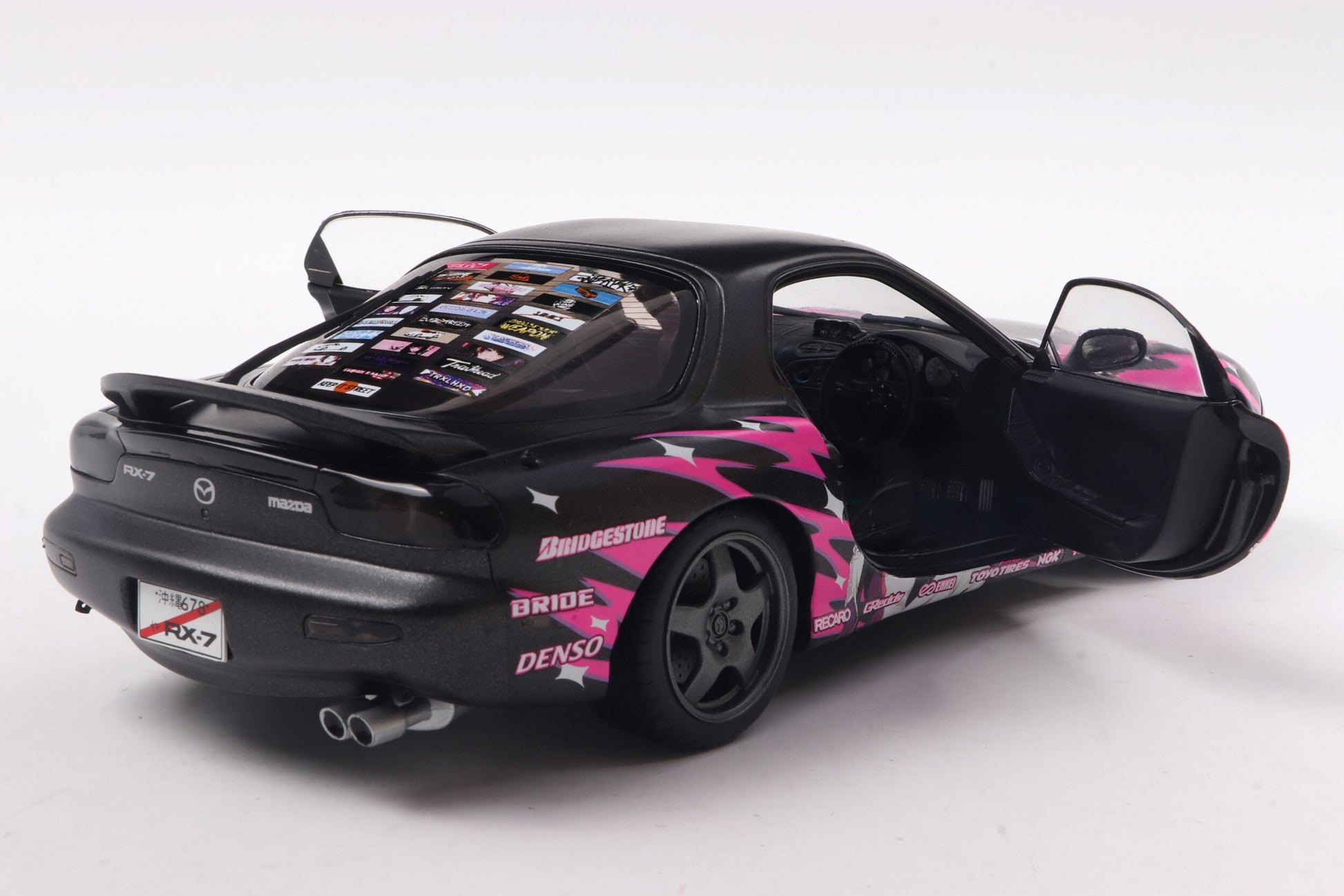Black sports car with pink and white design on a white background