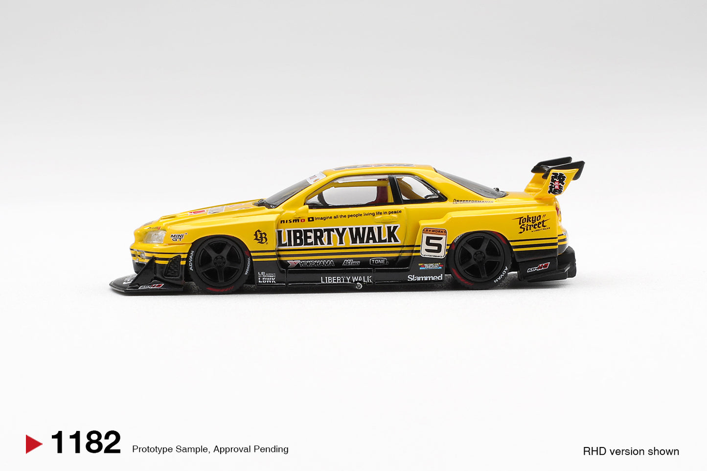 Side profile of Nissan LB-ER34 Super Silhouette Skyline Sport Yellow 1:64 scale model car with Liberty Walk livery (MGT01182)