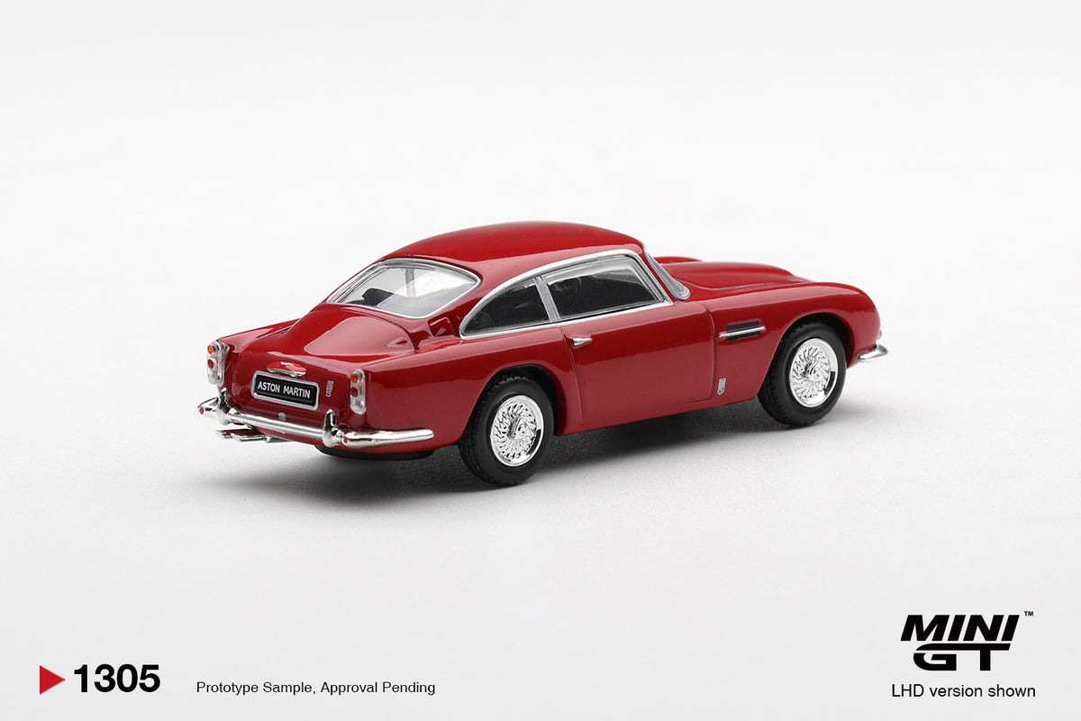 Mini GT Aston Martin DB5 Fiesta Red 1:64 scale diecast model car, rear three-quarter view showing the chrome rear bumper and tail lights