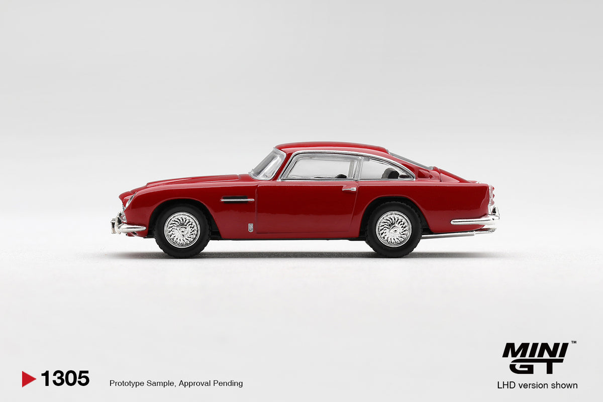 Mini GT Aston Martin DB5 Fiesta Red 1:64 scale diecast model car, side profile showing the fastback roofline and wire-spoke wheels
