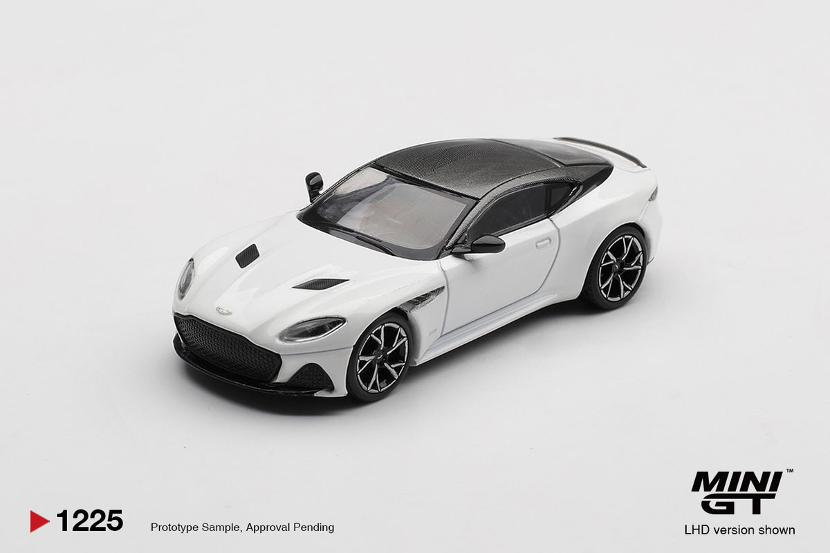 Front three-quarter view of Aston Martin DBS Stratus White 1:64 diecast model car by Mini GT showing the full-width grille and dark roof (MGT01225)