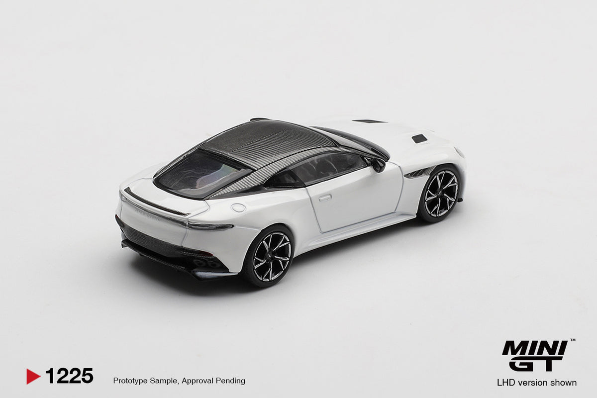 Rear three-quarter view of Aston Martin DBS Stratus White 1:64 diecast by Mini GT showing the haunched rear arches and quad exhausts (MGT01225)