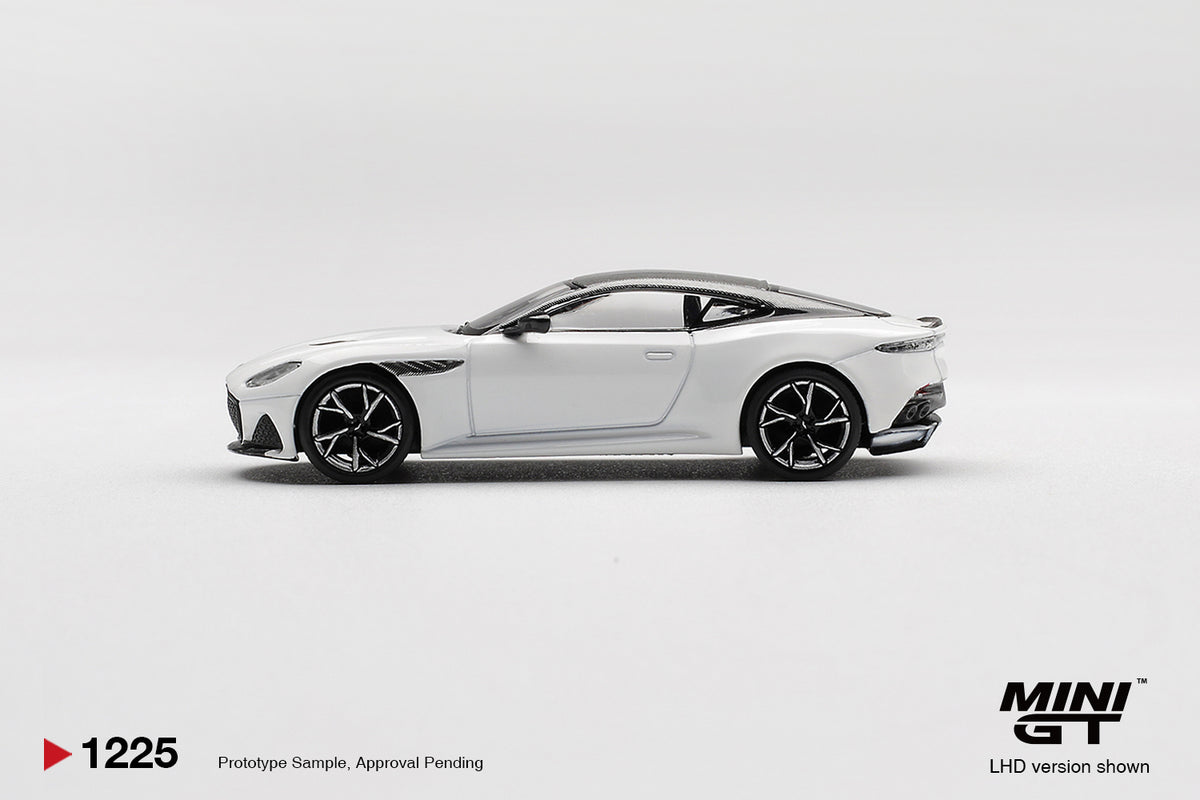 Side profile of Aston Martin DBS Stratus White 1:64 scale model car showing the long bonnet and dark multi-spoke wheels (MGT01225)