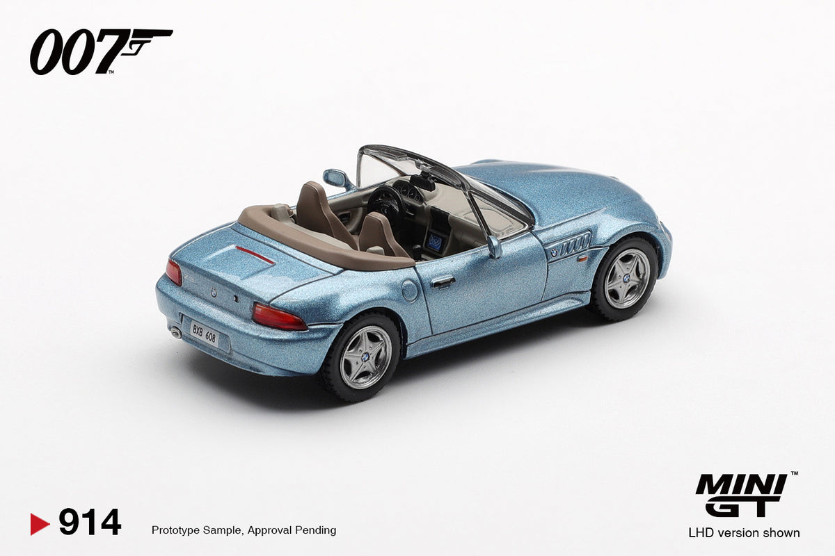Mini GT BMW Z3 GoldenEye 007 Atlanta Blue 1:64 scale diecast model car, rear three-quarter view showing the beige interior and folded tonneau behind the seats