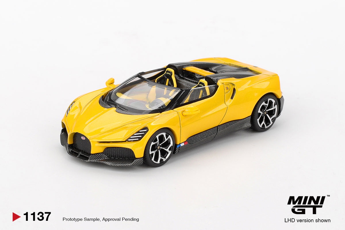 Mini GT Bugatti W16 Mistral yellow 1:64 scale diecast model car, front three-quarter view showing the black horseshoe grille and carbon fibre front splitter