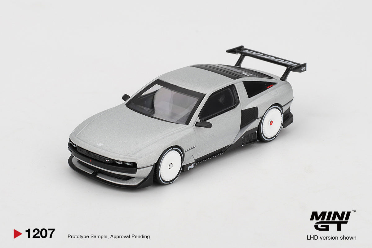 Mini GT Hyundai Concept N Vision 74 (VP2) silver 1:64 scale diecast model car, front three-quarter view showing the pixel-style front lighting and white aero-disc wheels