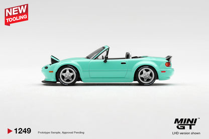 Mini GT Mazda MX-5 (NA) Pandem mint green 1:64 scale diecast model car, side profile showing the widebody arches and TOYO TIRES lettering