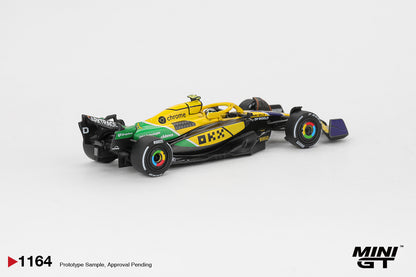 Front three-quarter view of McLaren MCL38 #4 Lando Norris 2024 Monaco GP 1:64 diecast model car by Mini GT in the yellow and green Senna tribute livery (MGT01164)