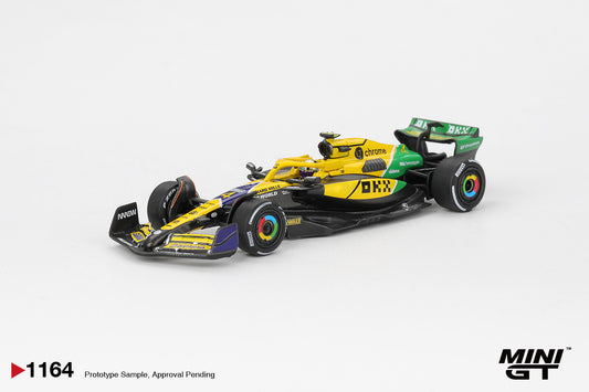 Rear three-quarter view of McLaren MCL38 Norris 2024 Monaco GP 1:64 diecast by Mini GT showing the rear wing and OKX branding (MGT01164)