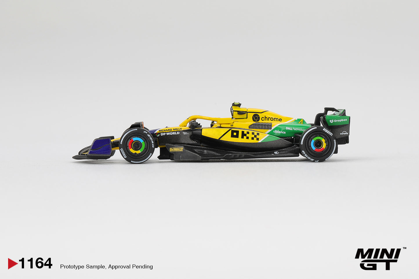 Side profile of McLaren MCL38 #4 2024 Monaco GP 1:64 scale model car showing the green sidepod flash and yellow engine cover (MGT01164)