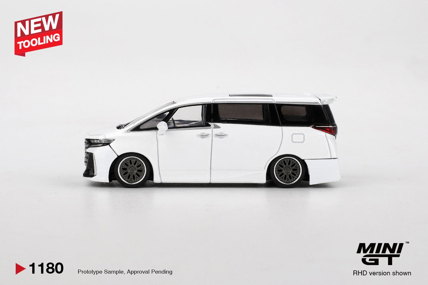 Side view of Toyota Vellfire 40 KUHL White 1:64 scale model car showing the slammed stance and dark multi-spoke wheels (MGT01180)