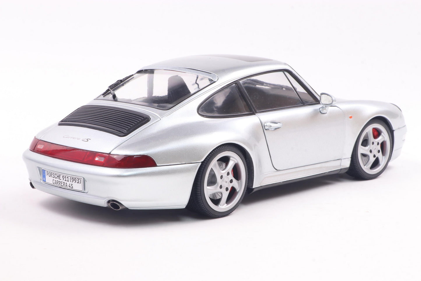 Back perspective view of Porsche 911 (993) 4S Polar Silver 1996 1:18 scale model car - Solido