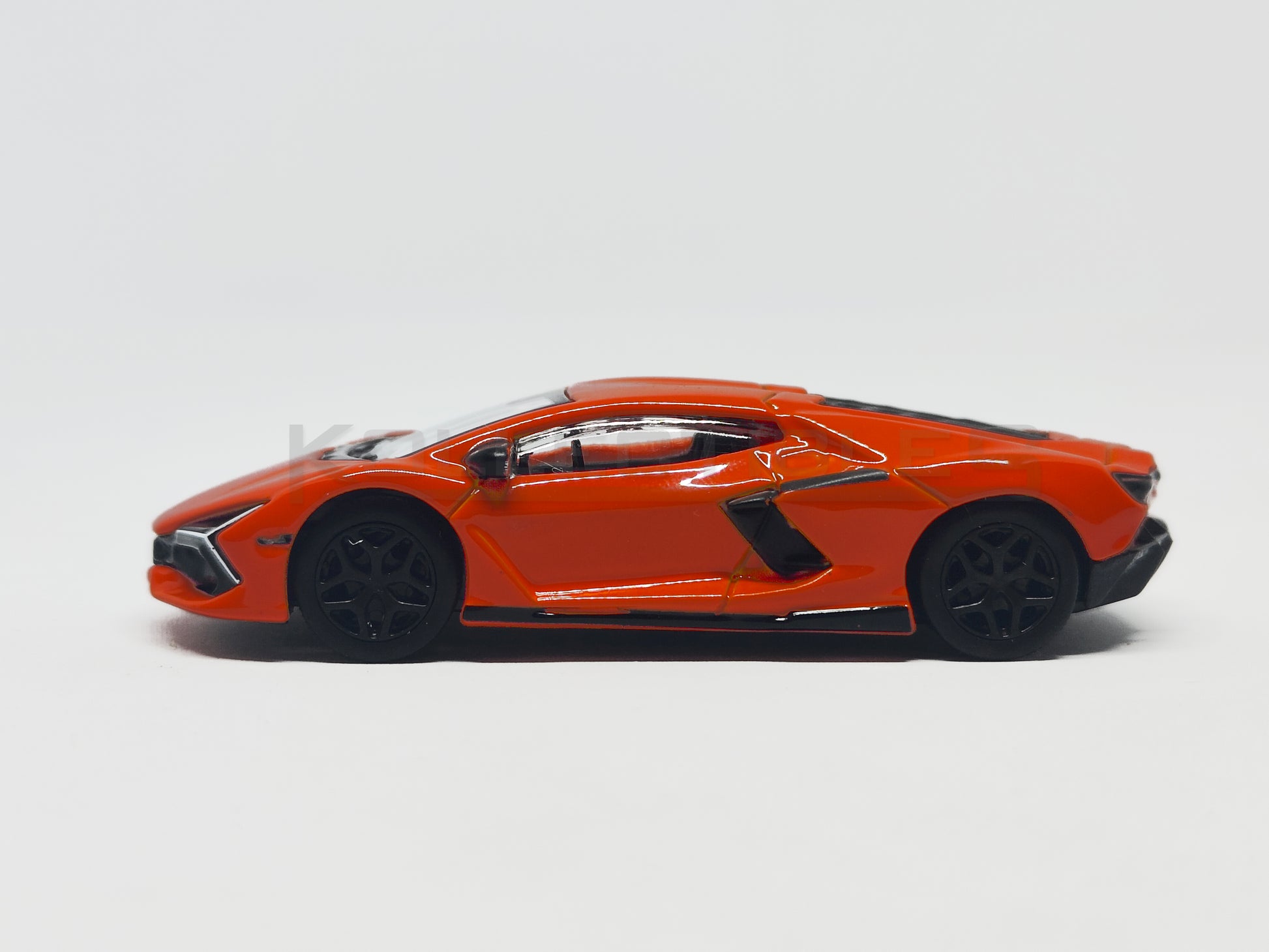 side1 of Lamborghini Revuelto Orange 1:64 scale model car - Bburago