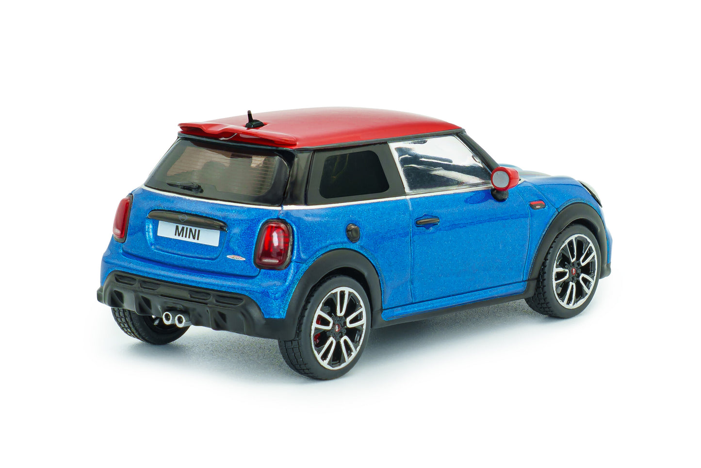 Rear three-quarter view of Mini Cooper John Cooper Works Island Blue Metallic 1:43 diecast showing the red roof spoiler, tail lights and twin centre exhaust (S4315003)