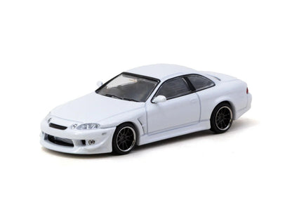 Front three-quarter view of VERTEX Toyota Soarer JZZ30 white 1:64 diecast model car by Tarmac Works showing the Vertex front bumper and deep-dish black wheels (T64G-080-WH)